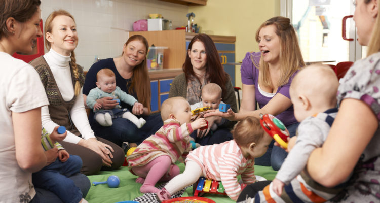 group, of, mothers, holding, children, at, daycare