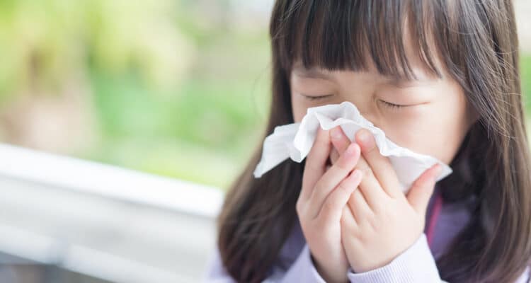 little, girl, with, tissue, blowing, nose